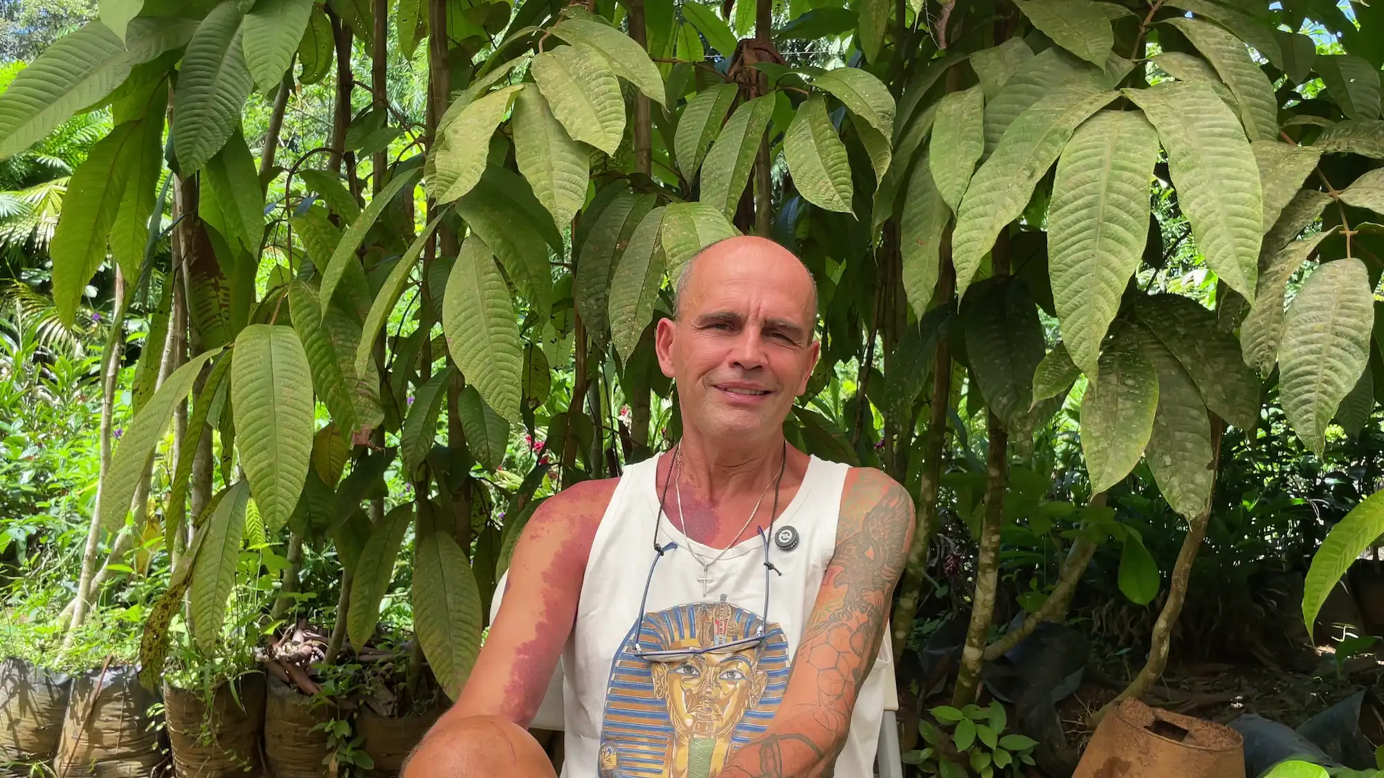 Lloyd standing among the plants at the homestead