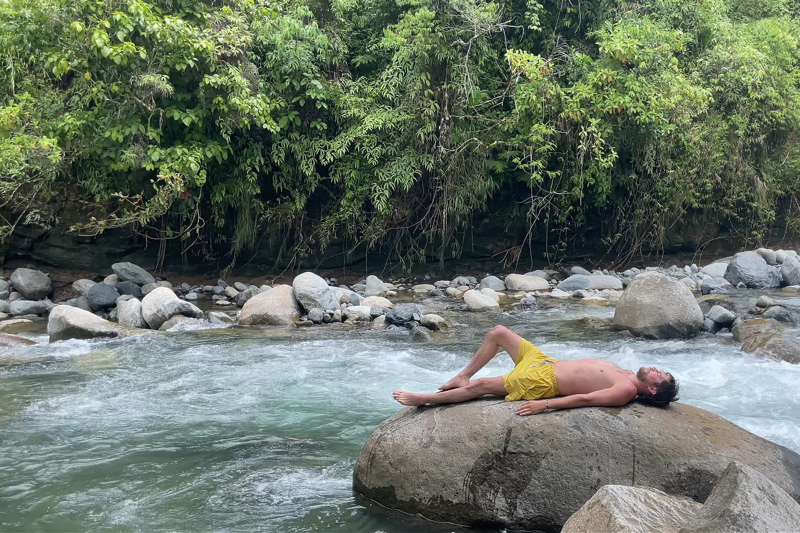 A participant resting beside the river.